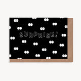 Surprise! Greeting card with black background and multiple cartoon eyes in the dark.