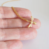 little lucky charm necklace bee photographed on finger to show size