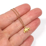 handheld image of little golden elephant charm necklace