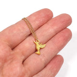 handheld image of little golden hummingbird charm necklace