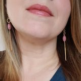 long earrings with hoop, pink bead and matchstick style drop, worn by model
